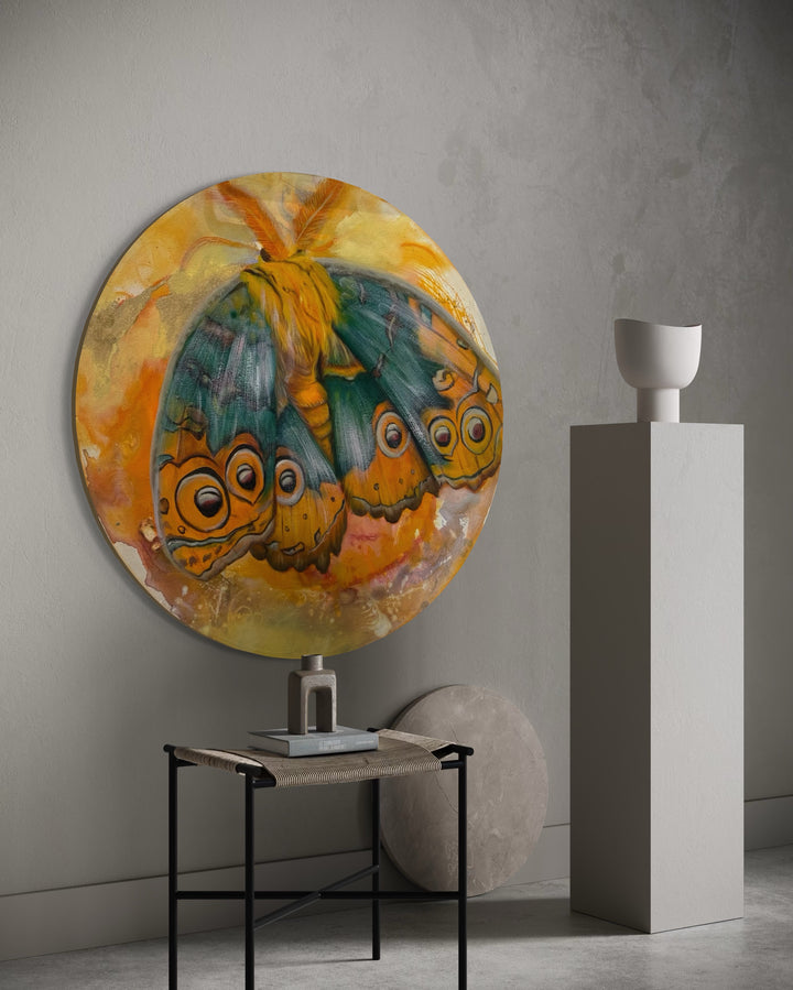 Round abstract painting with colorful butterflies on a wall in a modern interior setting.