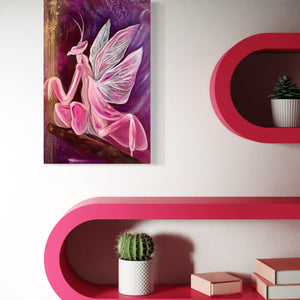A canvas painting titled 'Amethyst Embers' featuring a stylized, artistic representation of a pink mantis on a purple background, hung on a wall above pink floating shelves with a small potted cactus and books.