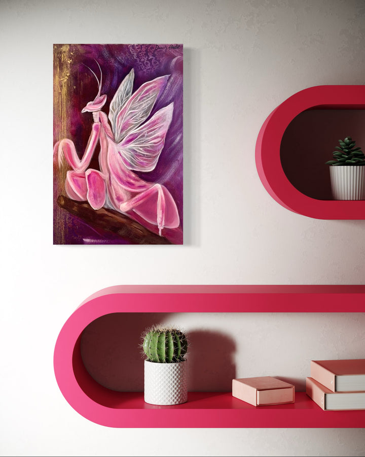 A canvas painting titled 'Amethyst Embers' featuring a stylized, artistic representation of a pink mantis on a purple background, hung on a wall above pink floating shelves with a small potted cactus and books.