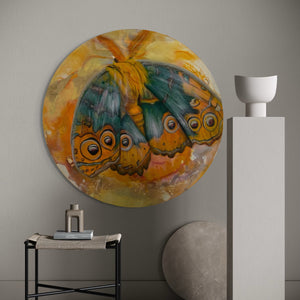 Round abstract painting of butterflies on a wall with minimal decor.