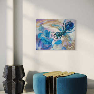 Abstract painting on a wall above a blue ottoman with gold accents.
