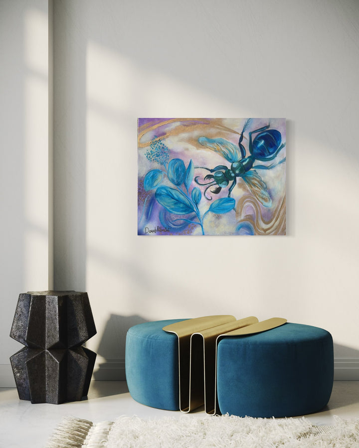 Abstract painting on a wall above a blue ottoman with gold accents.