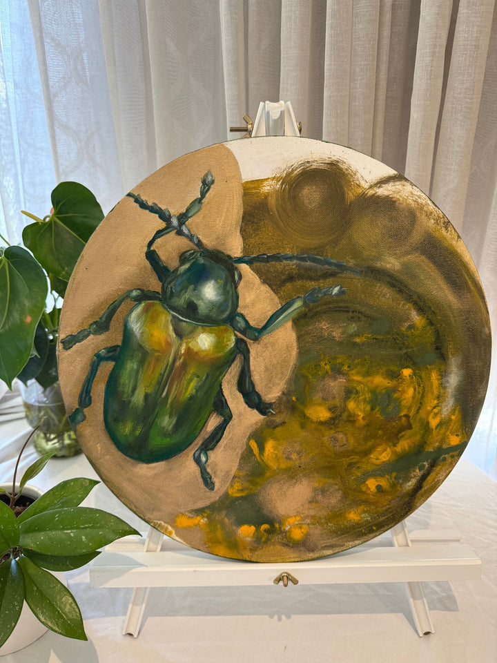 A canvas painting featuring a realistic green beetle on a circular canvas, with a background that blends into an abstract pattern of yellow and green hues.
